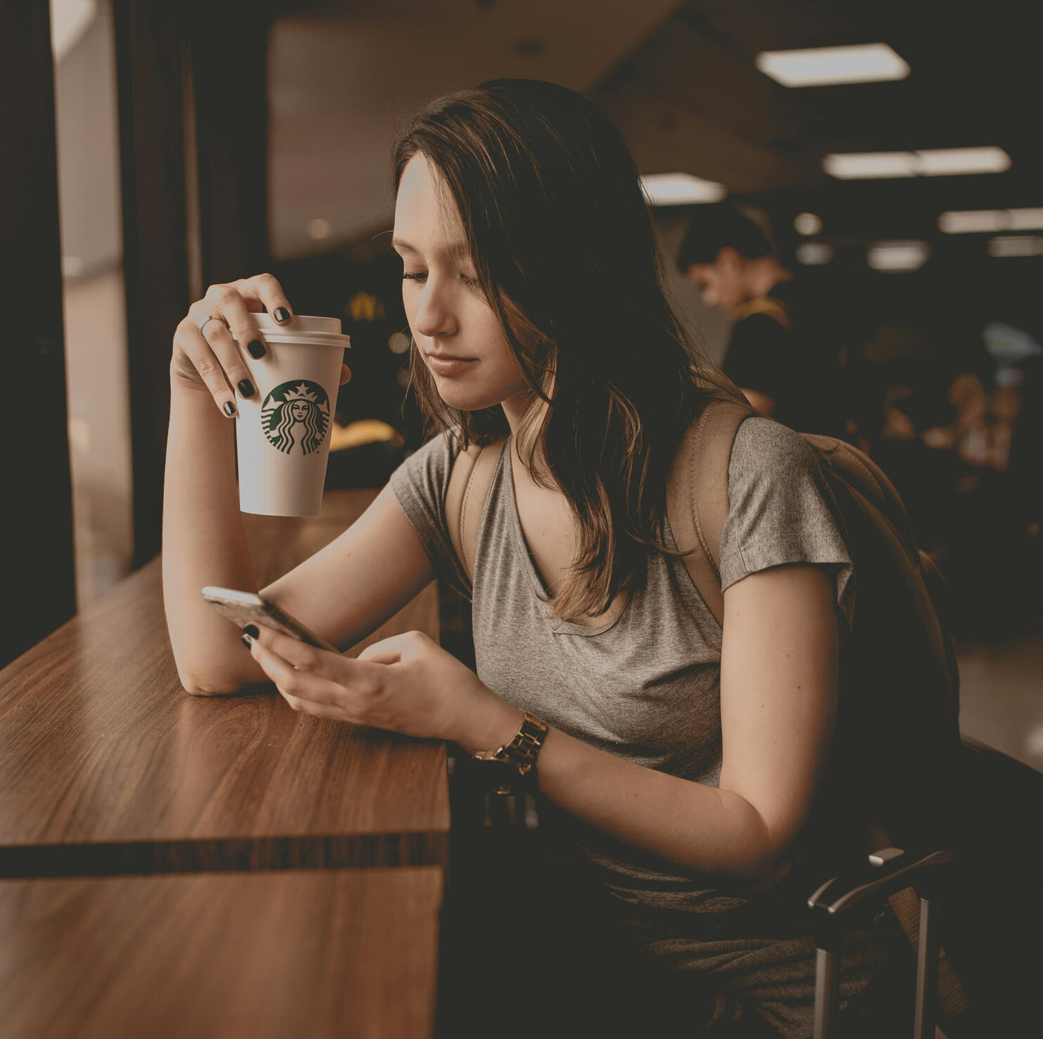 89Sites Small Biz Web Design - Girl Drinking Coffee and browsing on phone